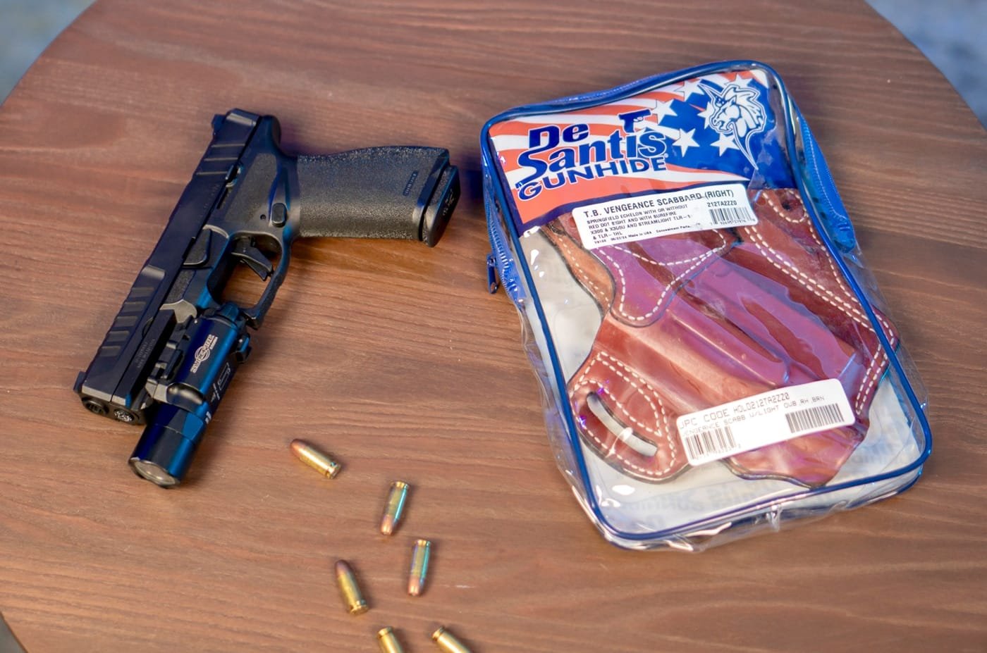 In this detailed photograph, a pistol is being carefully secured into the DeSantis T.B. Vengeance holster, demonstrating its reliable retention system. The image emphasizes the holster’s robust construction using American full-grain steer leather and its precise, reinforced stitching around the belt loops. The design includes an innovative thumb break for easy yet secure drawing, ideal for real-world use in both tactical and everyday situations. It is perfectly suited for various carry styles, including concealed carry and open carry, ensuring that the firearm remains safely in place. The craftsmanship and quality of this holster are evident in every detail of its design. Keywords such as holster, handgun, pistol, concealed carry, firearm retention, premium leather holster, and scabbard holster are included to enhance the description. This ALT text is crafted to help visually impaired users fully understand the secure, high-quality nature of the DeSantis T.B. Vengeance holster review.