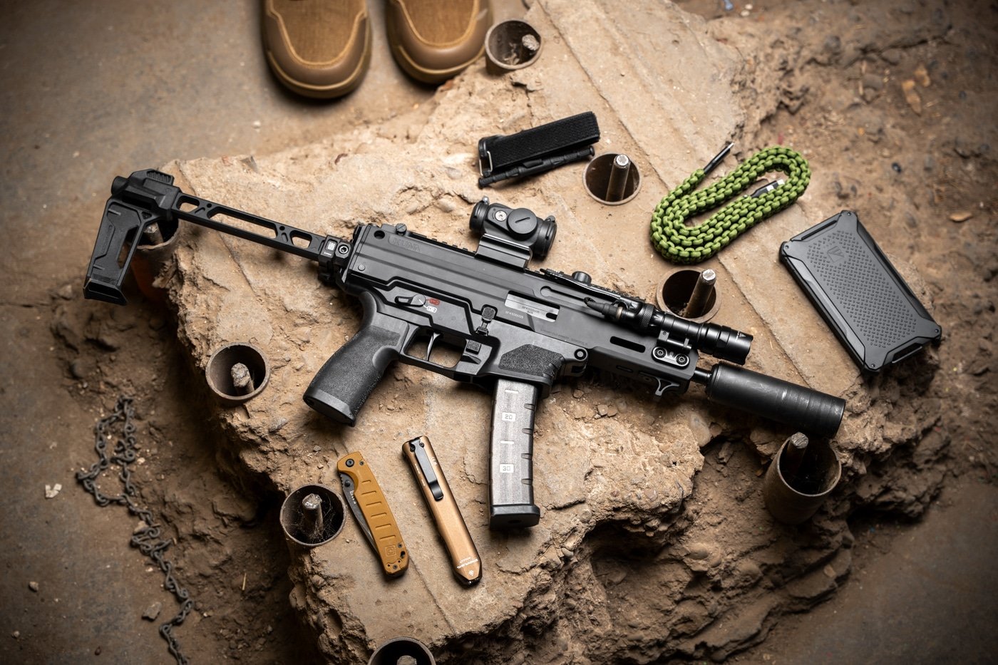 The Springfield Armory Kuna, shown in this photograph, is fitted with a 9mm suppressor, a Surefire tactical flashlight and a red dot sight. A PDW-style pistol, the Kuna is a solid choice for home defense as it can be accessorized for your specific needs.