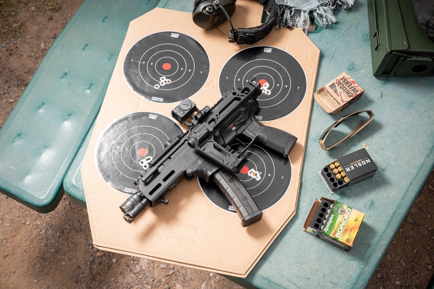 In this photograph, we see the author's targets that represent his accuracy testing done with the Kuna semi-automatic pistol.