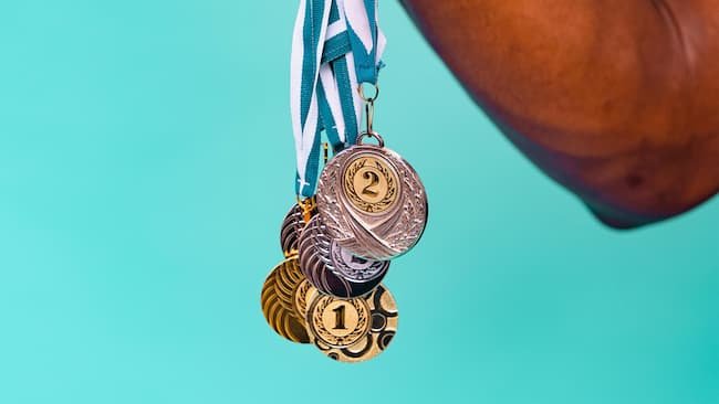 a collection of gold and silver Olympic medals