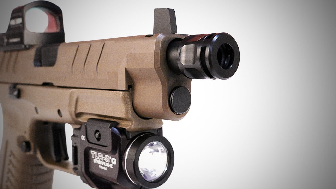 Griffin Micro Carry Comp Review Shown in this photo is the Griffin Micro Carry Comp attached to the threaded barrel of a Springfield Armory, Inc. XD-M Elite Tactical OSP semi-automatic pistol. The handgun has a dark flat dark earth, or FDE, finish.