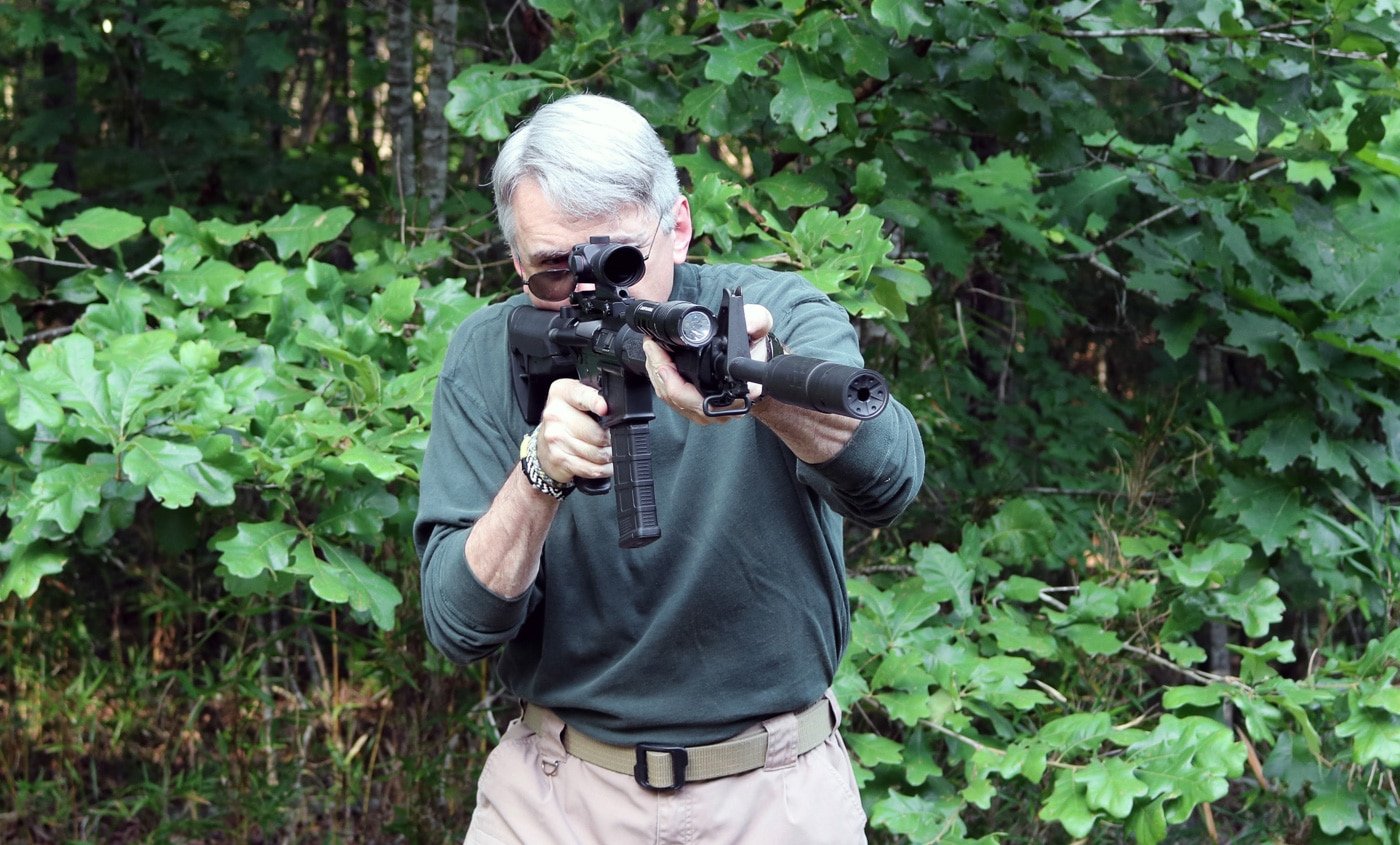 author shooting a Springfield Armory SAINT with an attached suppressor