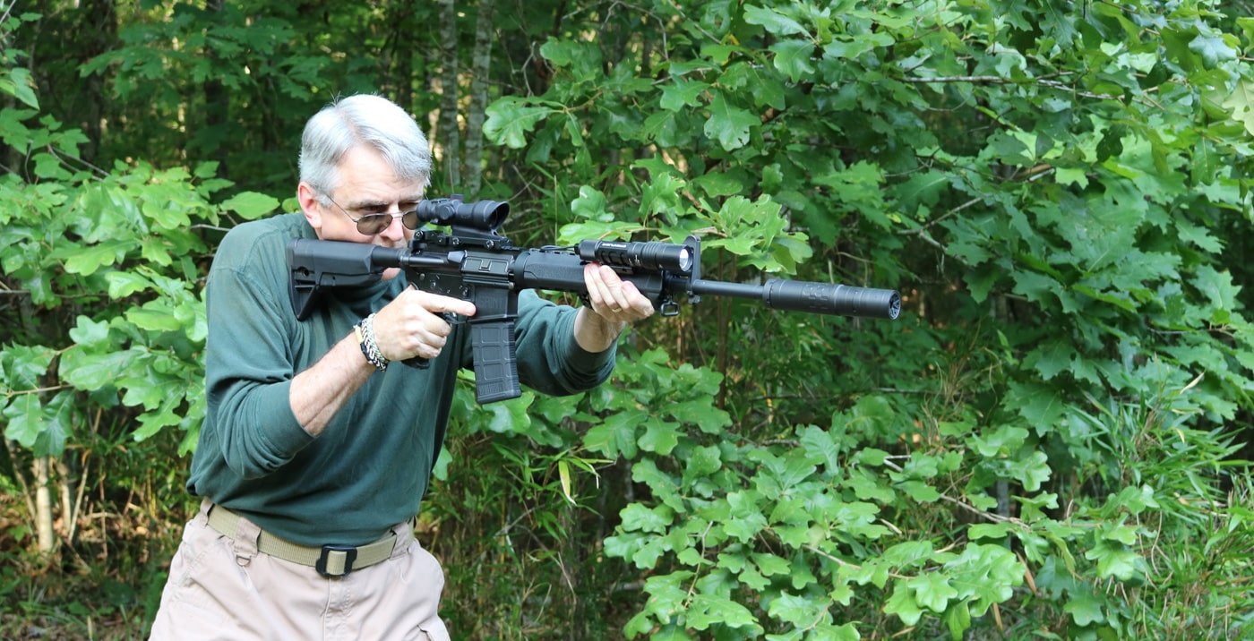 author shooting his suppressor equipped SAINT ar-style rifle at the shooting range