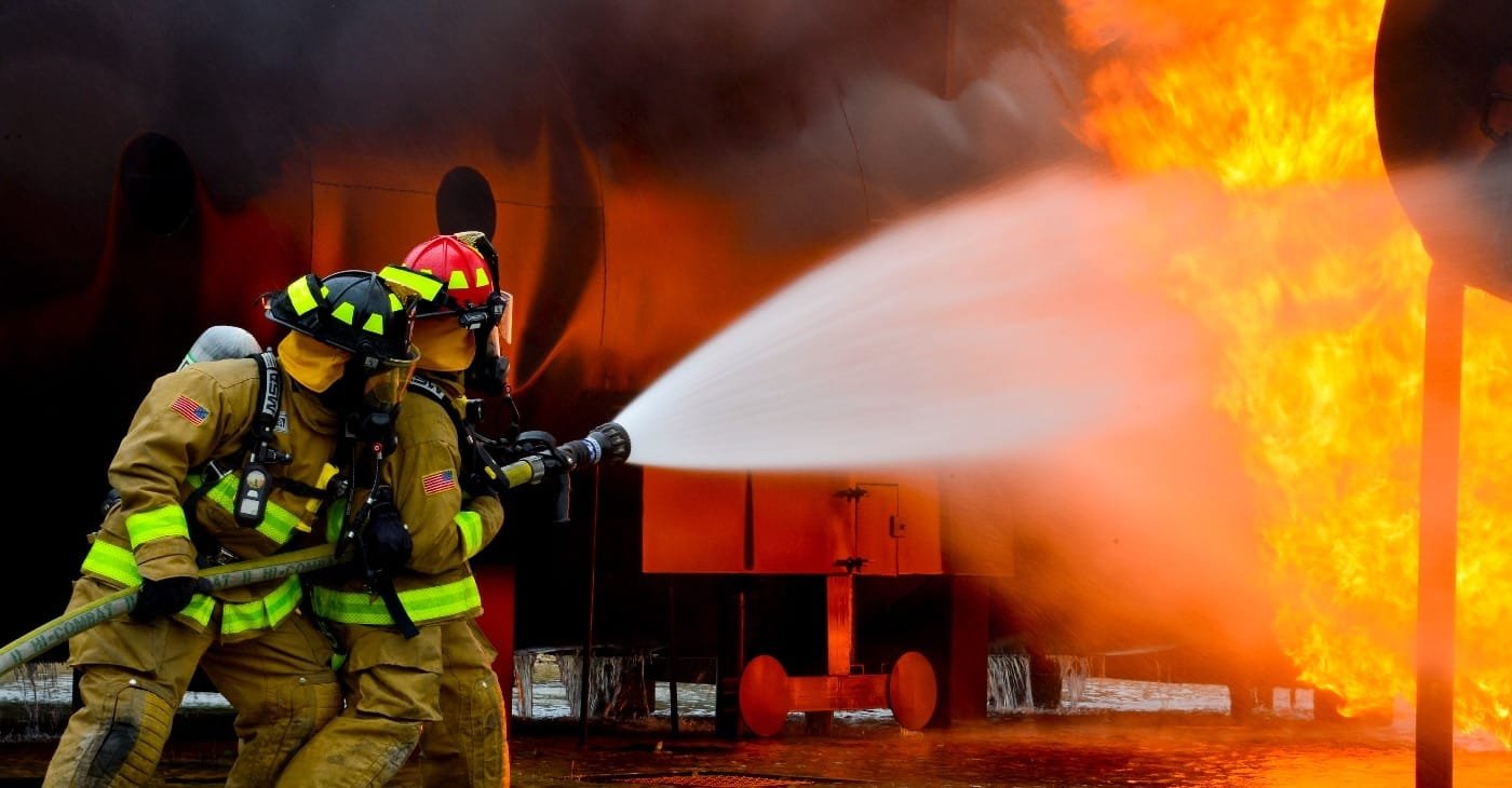 volunteer firefighters training with hose